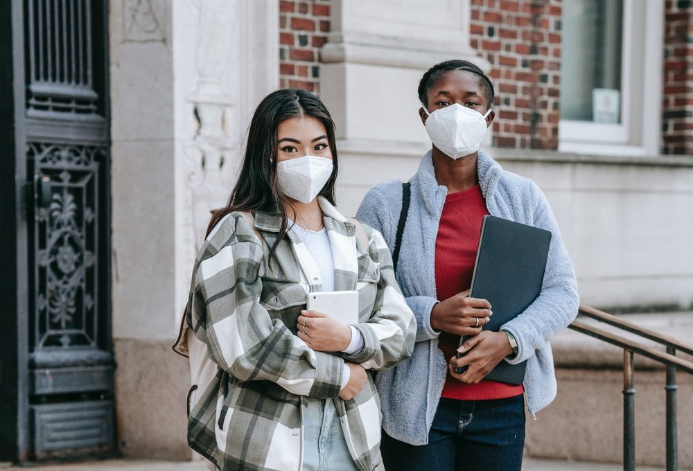 Student couple posing for photo with their masks on