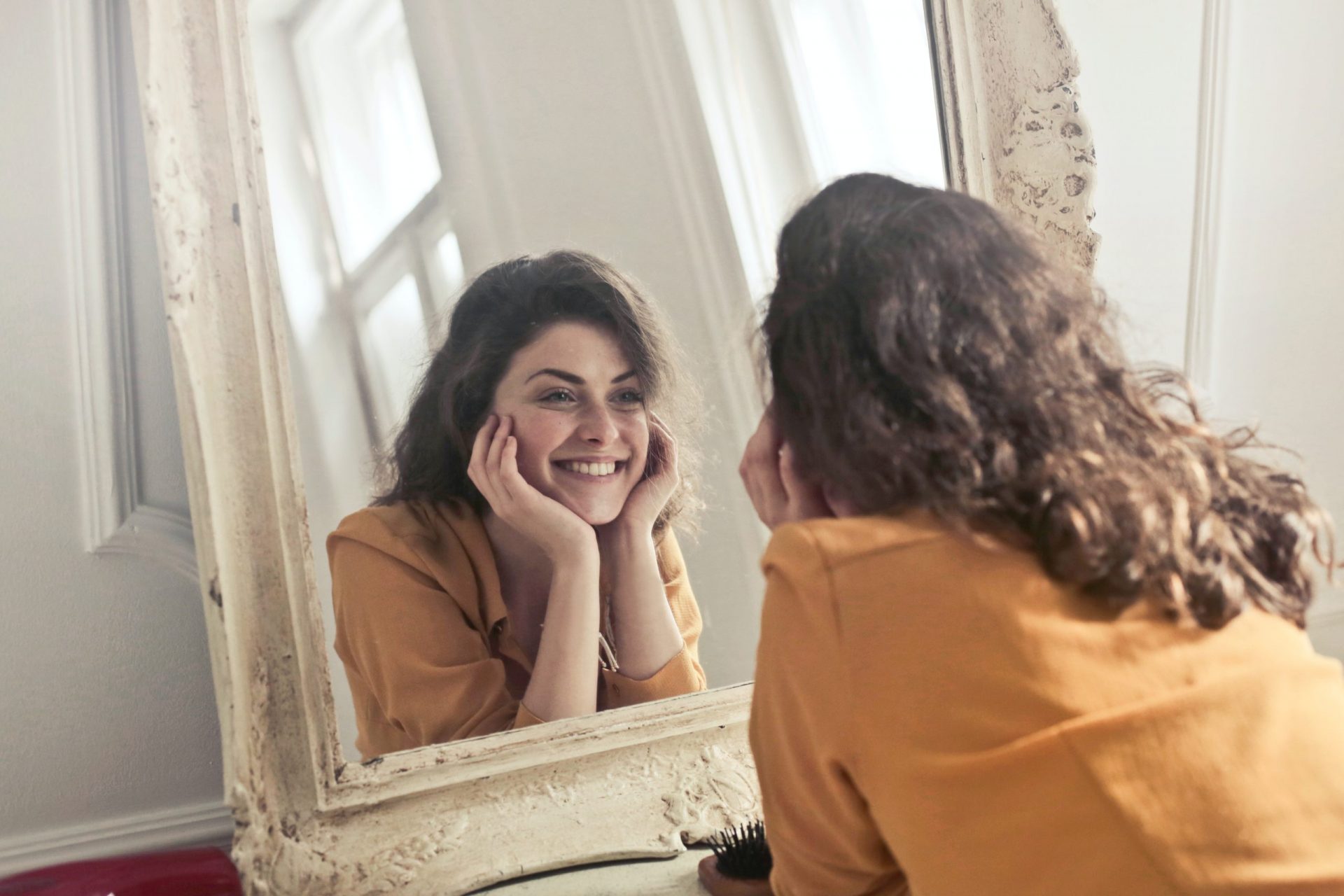 woman smiling in a mirror