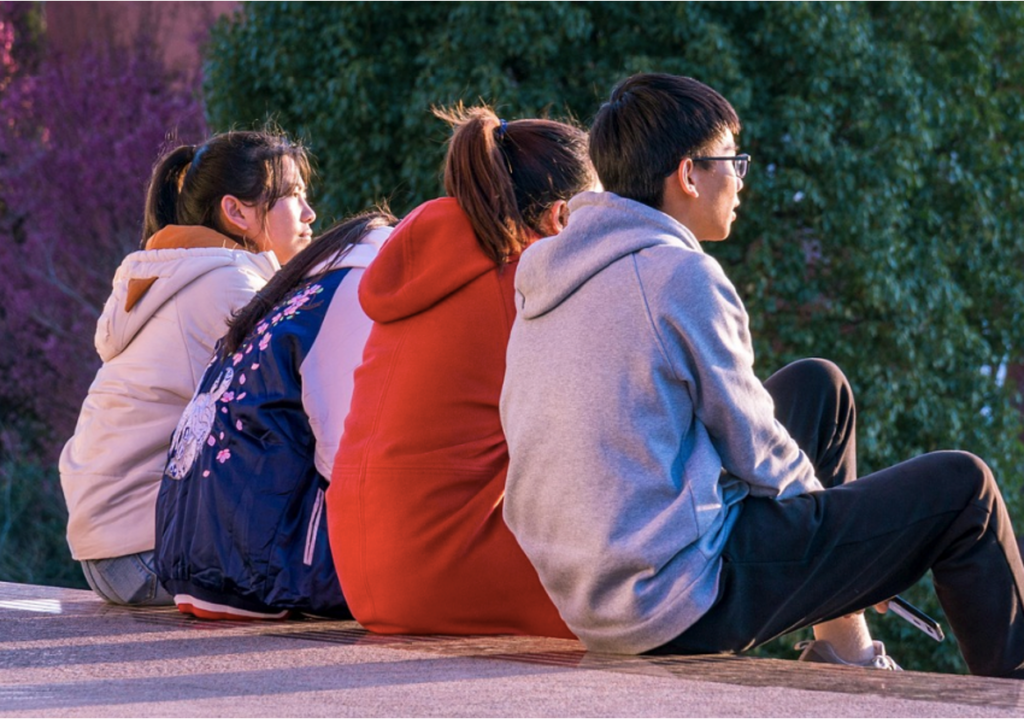 A group of teenagers hanging out together, showing how peer pressure builds easily