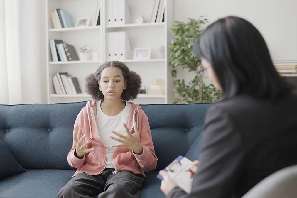 A young female teen is opening up with her therapist, and the treatment is clearly working. 