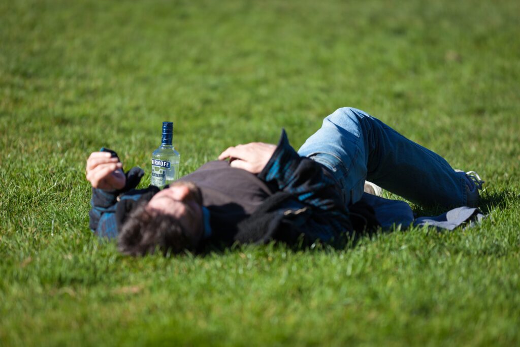 Male teen is extremely drunk/passedout on the ground and is clearly in need of treatment. 