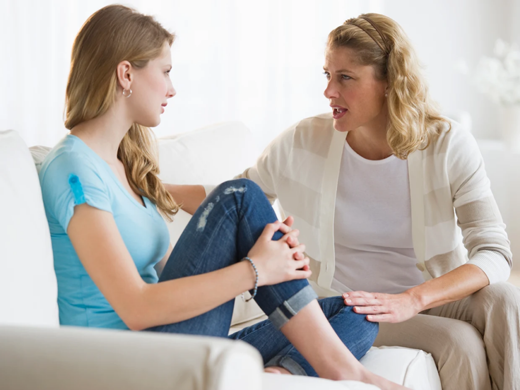 A young mother speaking with her teen daughter; she learned that parental involvement is key to preventing teen drug usage. 