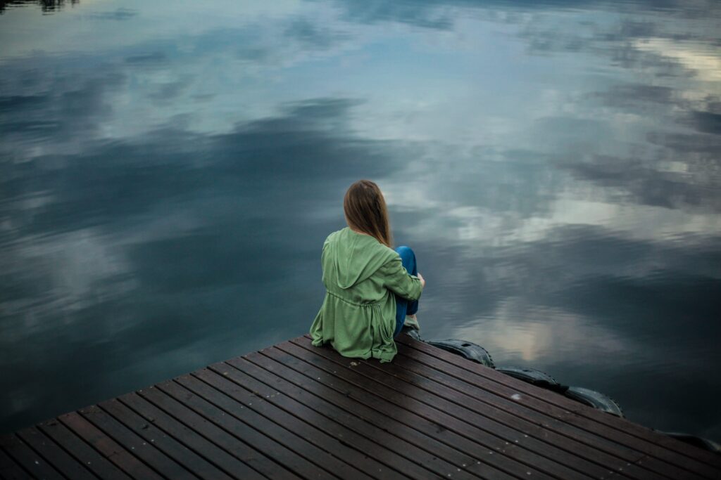 A young female teen on a deck contemplating suicide. There is a clear need of treatment here at Clearfork Academy. 