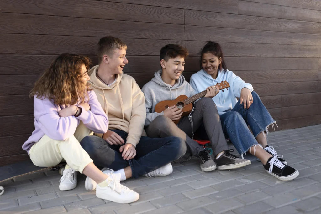 A group of teens playing the ukulele after a group session here at Clearfork Academy.