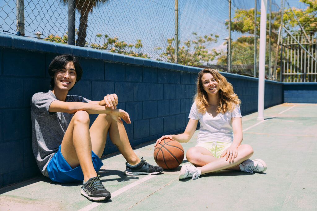 Teens play basketball as an alternative to playing video games.