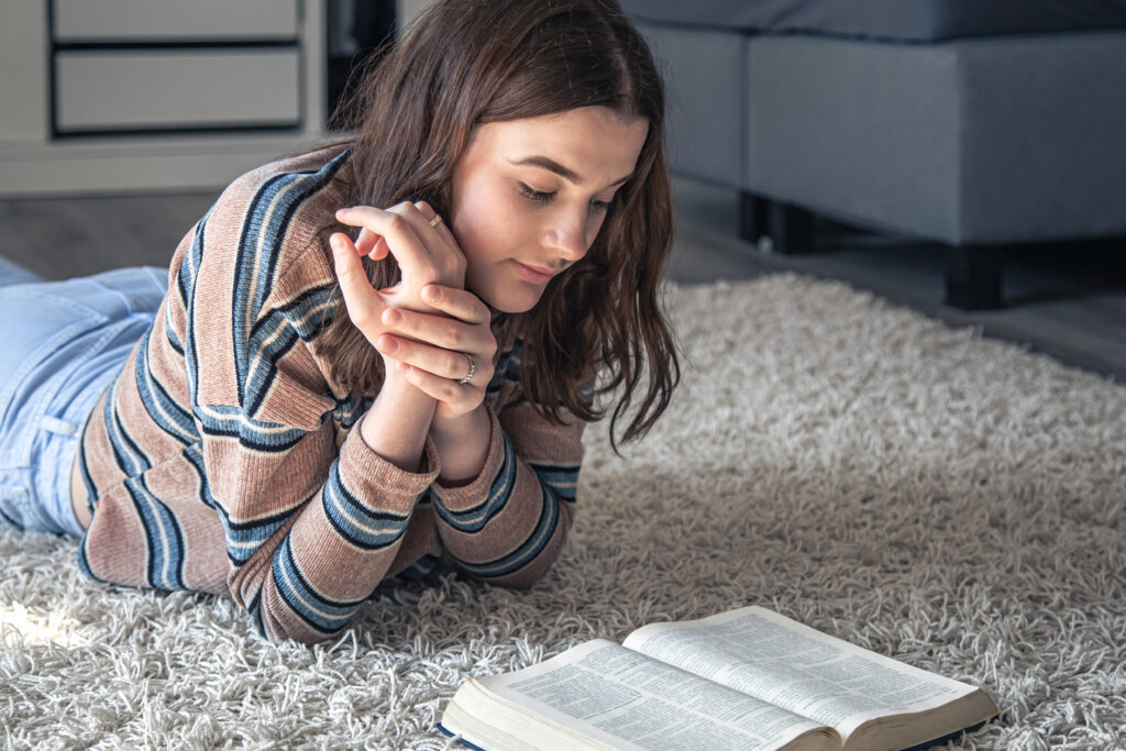 A female teen reading her bible; as part of our Christian faith-based approach. 