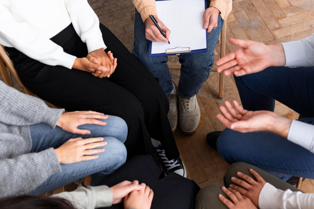 Teens in group therapy prepare an activity that helps improve their mental health. 
