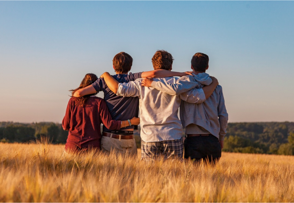 A group of teenagers hugging each other, looking relieved and sober after undergoing treatment at Clearfork Academy