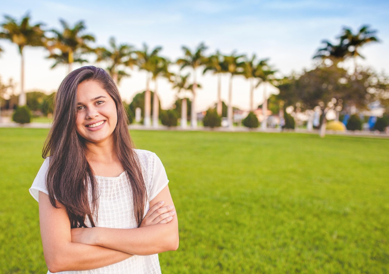 A happy teenager posing in front of a teen residential treatment center in Texas, showing that recovery is possible