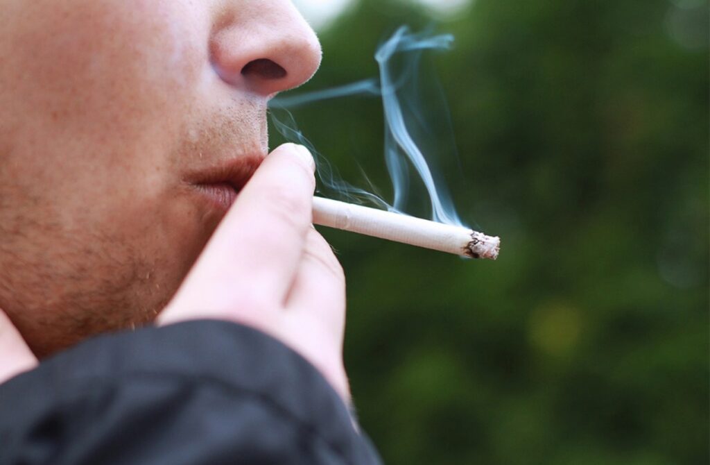 A teenager smoking marijuana to cope with their problems