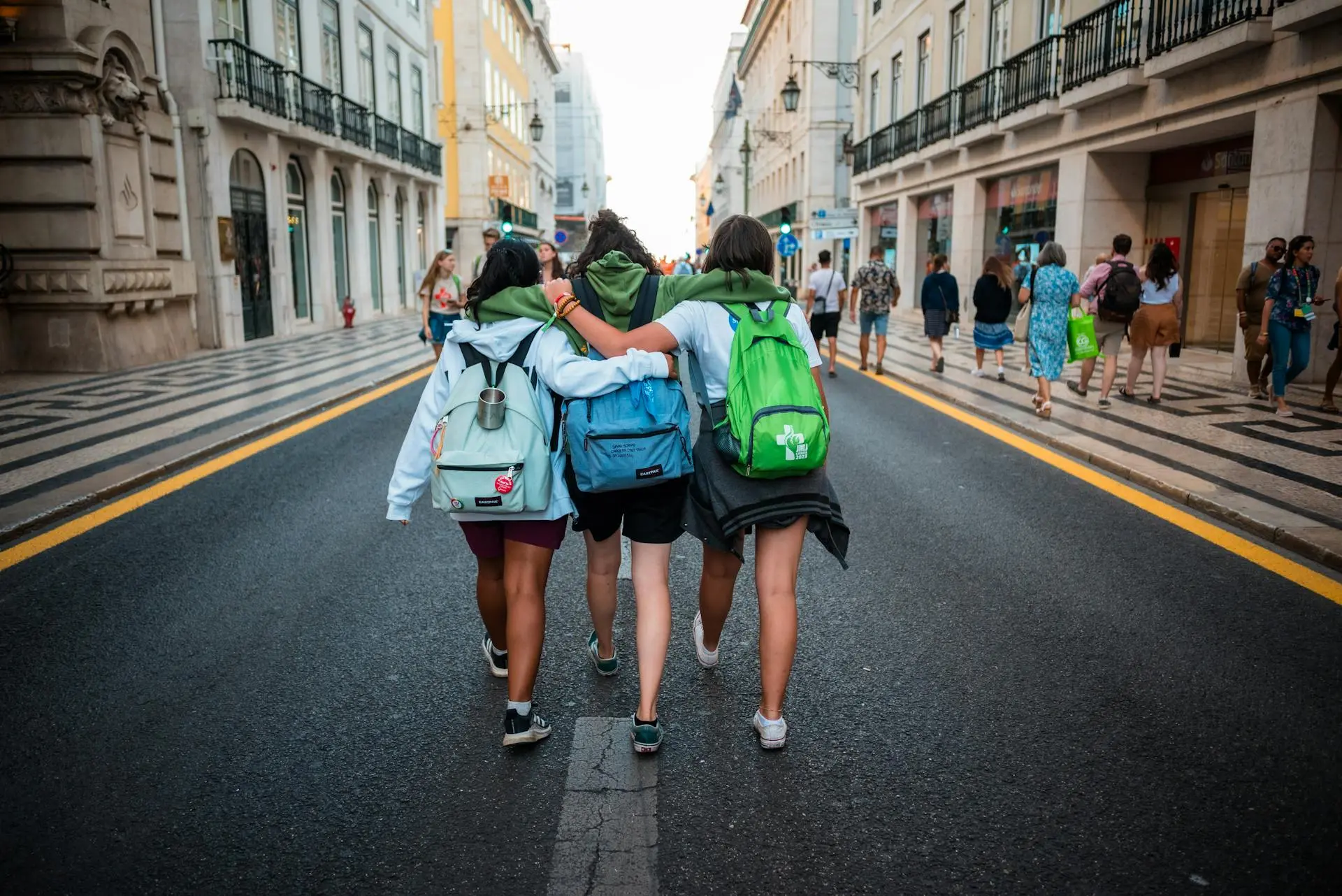 Three teens were walking down a street