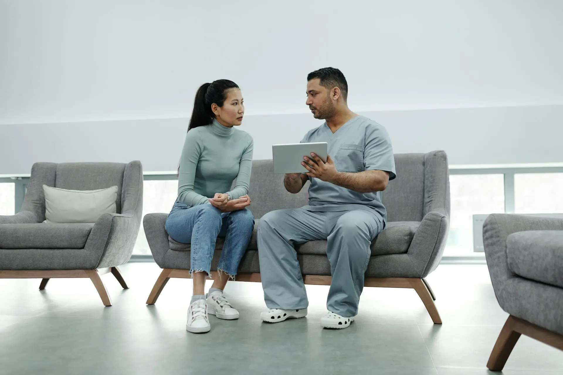 Woman sitting down talking with a doctor