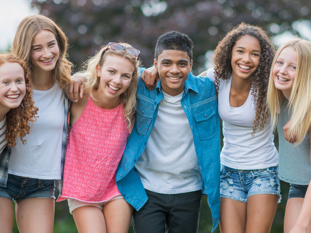 happy young adults in a circle
