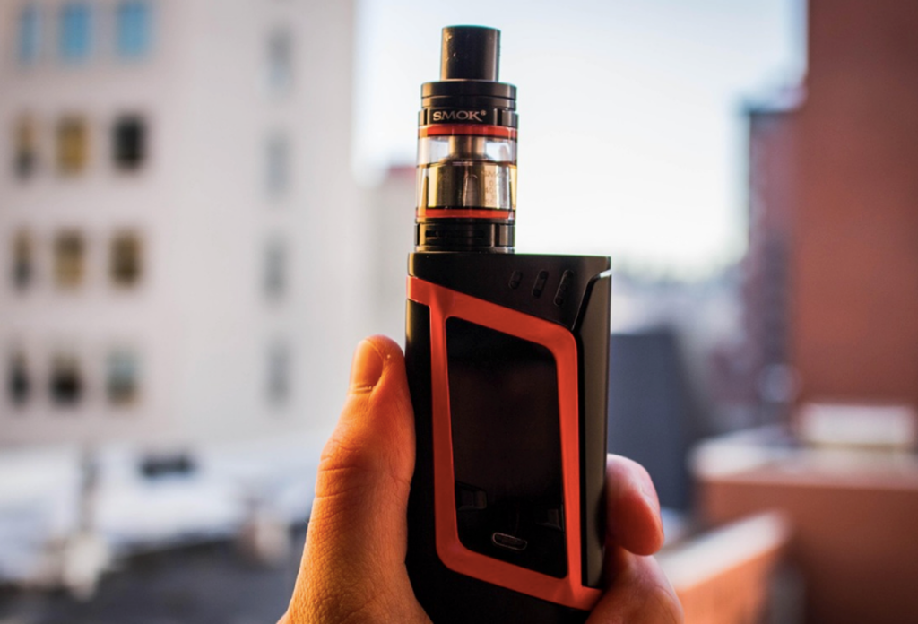 A person holding a vape to put it out of reach