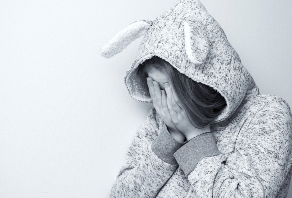 A teenager appearing uninterested and frustrated