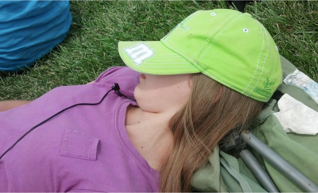 A teenager taking a nap during the day outdoors