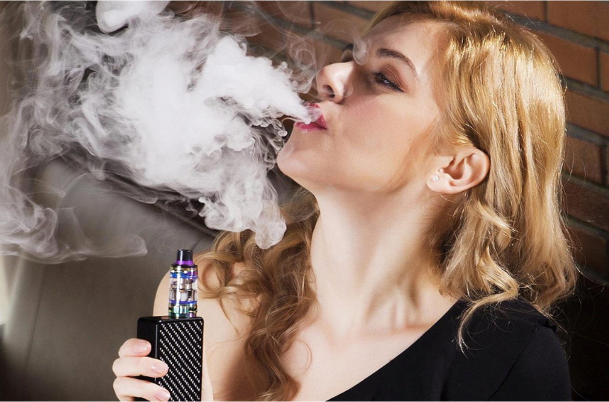 A teenager using a vape device, illustrating the vaping habit parents may notice in their child