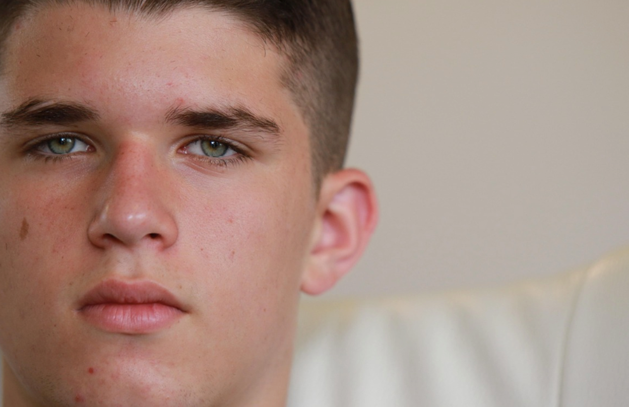 Close-up view of a troubled teen deep in thought