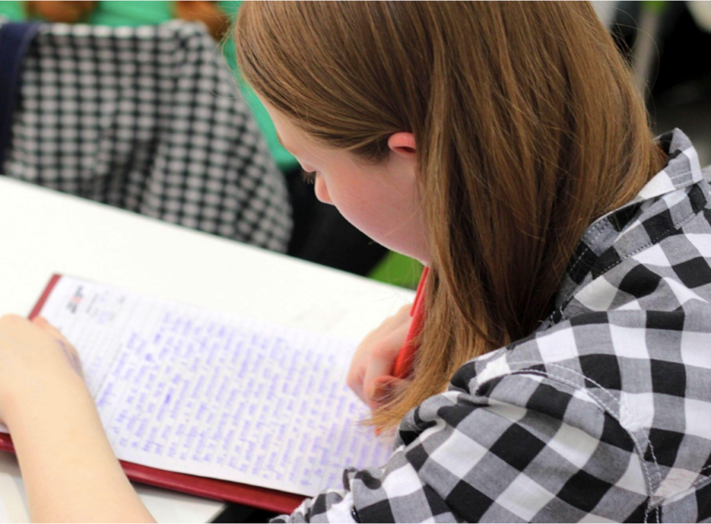 A teen undergoing academic exercises while in a residential treatment center