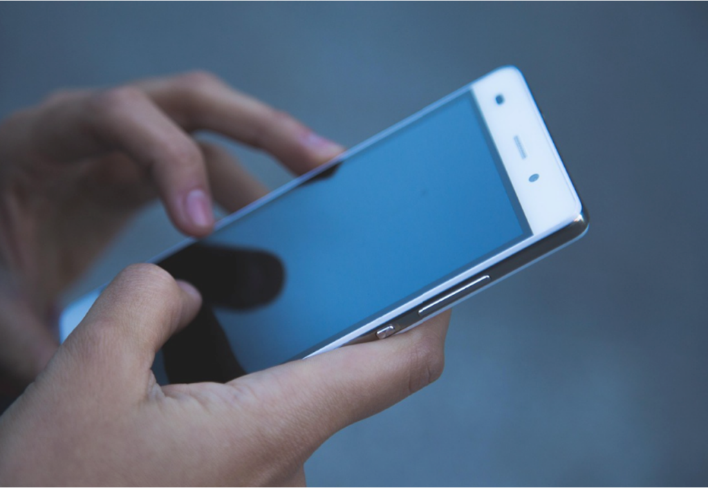 A teenager using a smartphone before bed