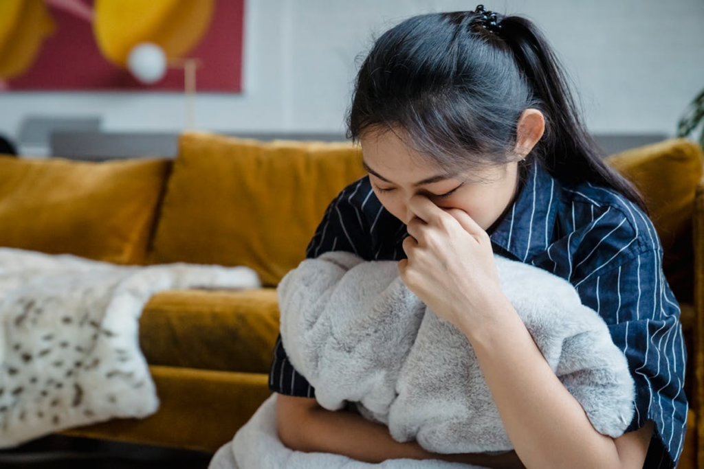 A young person feeling nauseated while going through severe fentanyl withdrawal