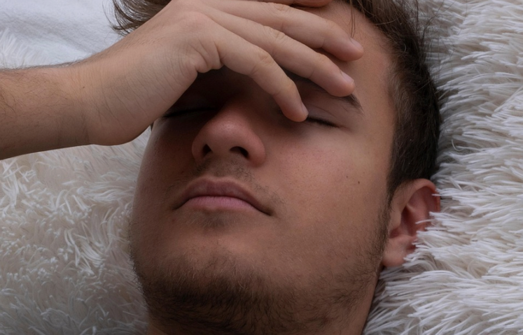 A young person in pain, suffering from a head injury