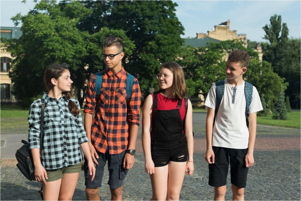 A group of teenagers walking together outdoors.