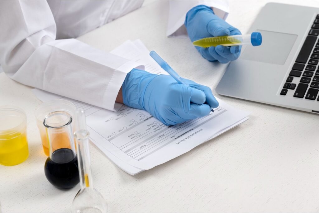 Medical professional performing an examination using a urine sample.