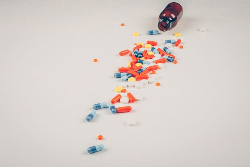 Scattered counterfeit prescription pills on a surface.
