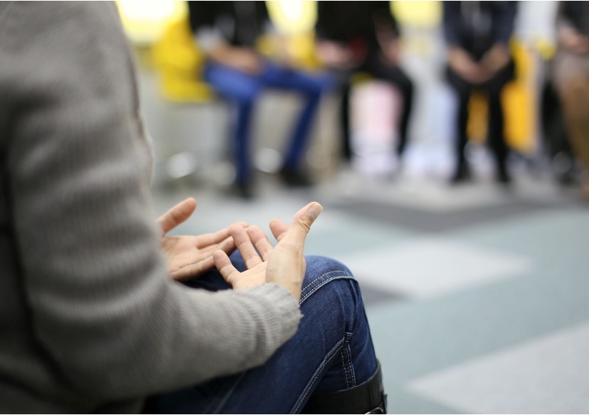 A counselor leading group therapy for teens struggling with cocaine addiction