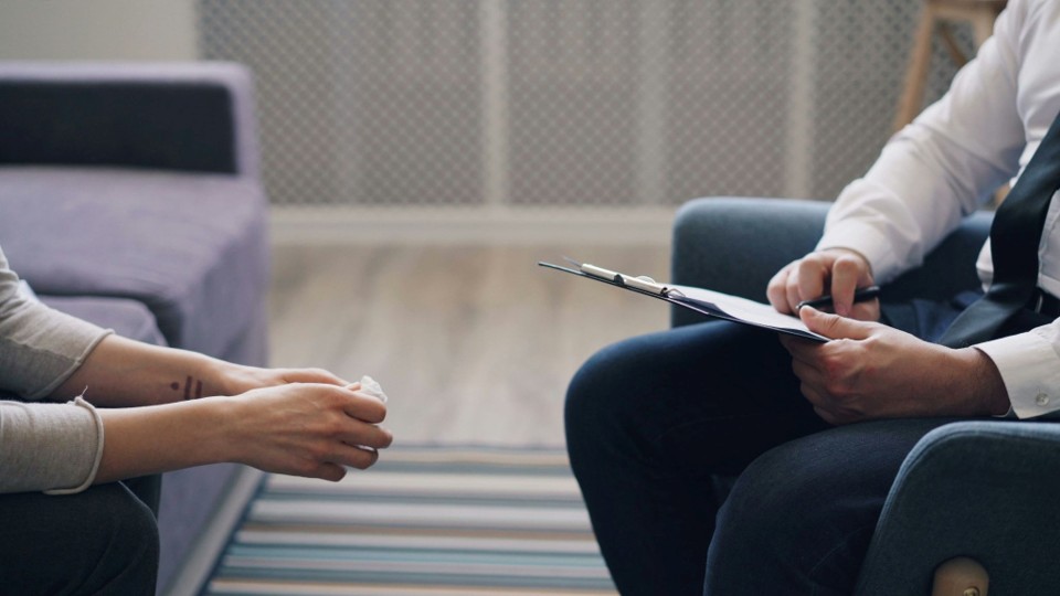 Psychotherapy session between a teen and a therapist 
