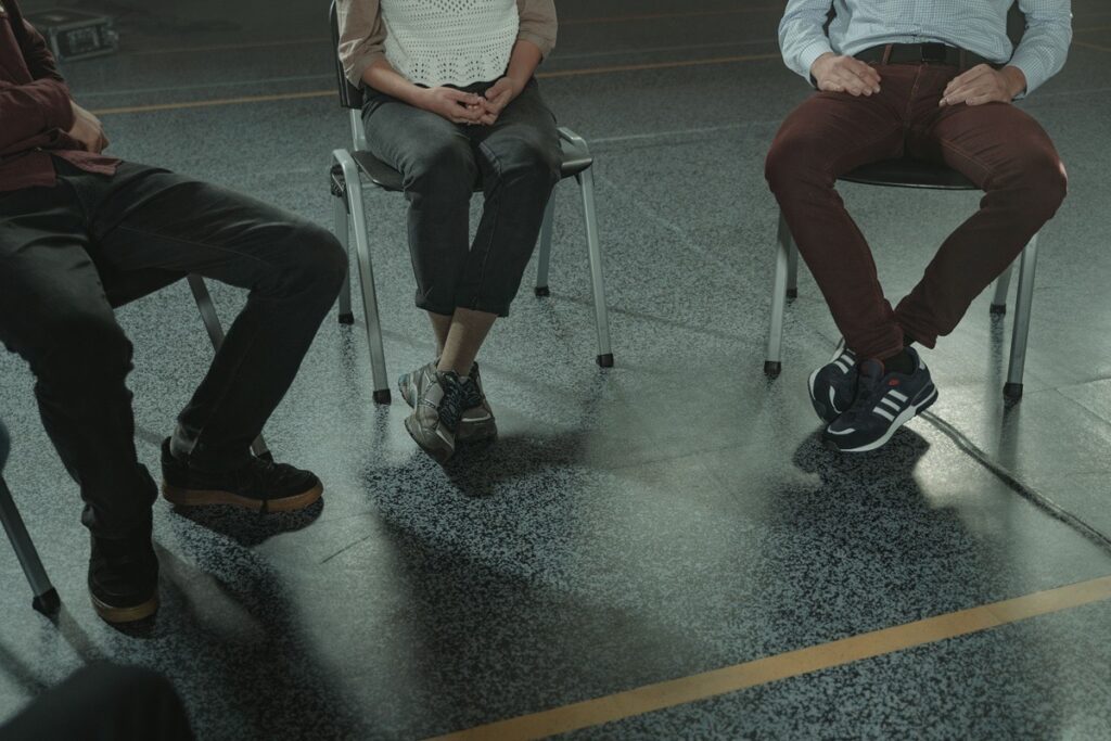 People seated in a circle during a group therapy session